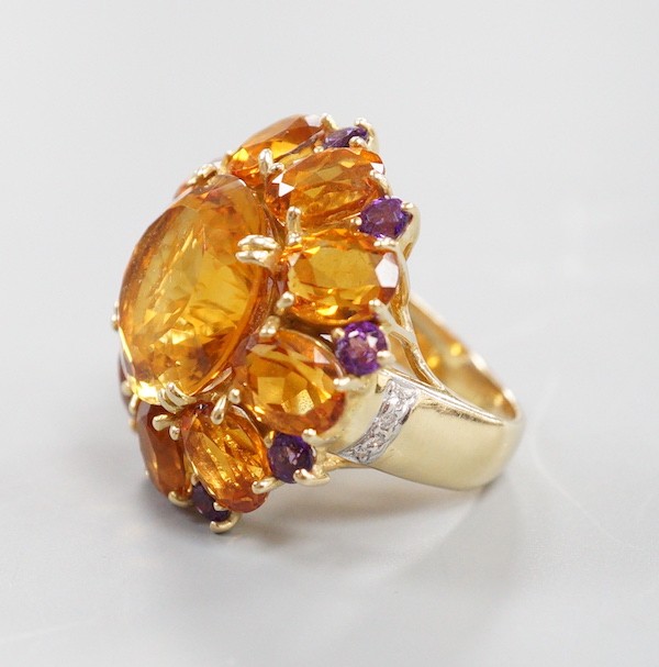 A large 14k, citrine and amethyst cluster set flower head dress ring, with diamond chip set shoulders, size H, gross weight 11.4 grams.